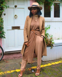 Brooke Etebu wears camel colour coat