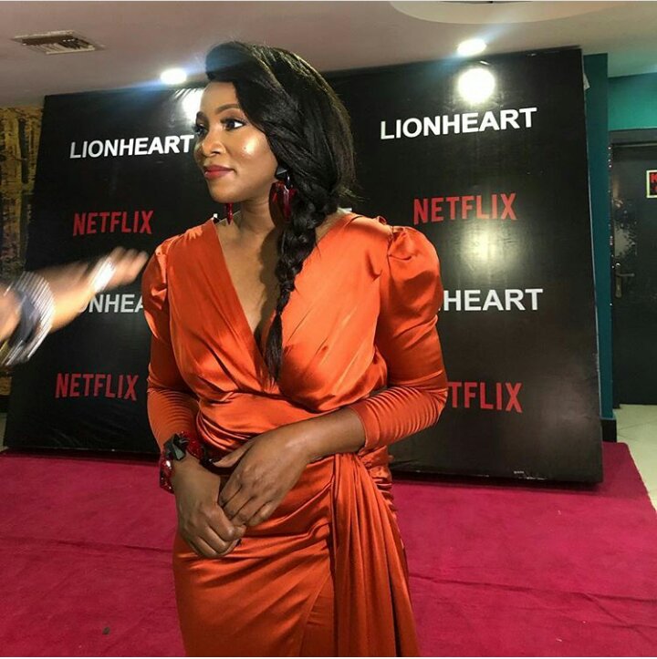 genevieve nnaji orange dress to lion heart movie premiere